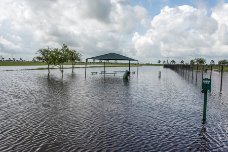 Standing flood waters covering fields and trailsの写真素材