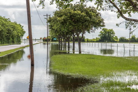 Standing flood waters covering fields and trailsの写真素材