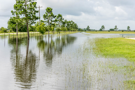 Standing flood waters covering fields and trailsの写真素材
