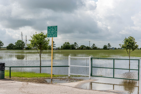 Standing flood waters covering fields and trailsの写真素材