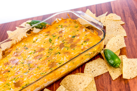 hot layered bean dip with jalapenos, sour cream and melted cheddar cheeseの写真素材