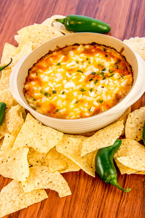 hot layered bean dip with jalapenos, sour cream and melted cheddar cheeseの写真素材