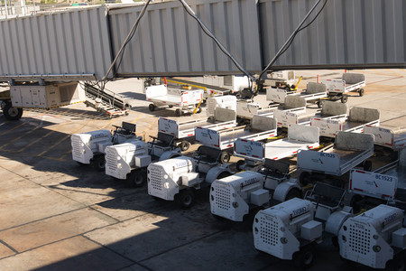 October 2, 2015, Phoenix, Arizona, USA - PHX airport. Luggage and carts on the ramp.