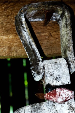 worn equestrian riding gear hanging in a barnの写真素材