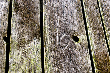 Grey and knotted aged outdoor weathered barn woodの写真素材