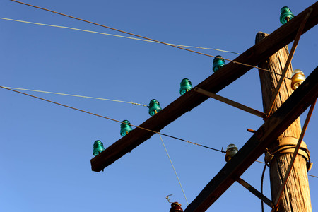 old wooden power poles with glass insulatorsの写真素材