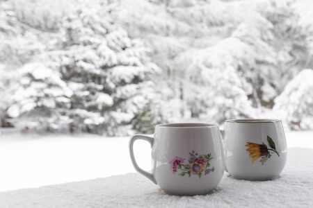 Cup of coffe on table with snow