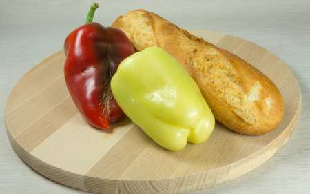 Organic pepper and bread on wood boardの写真素材