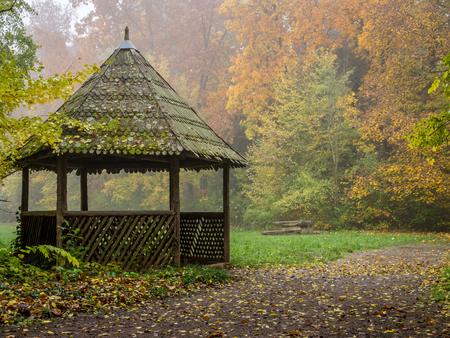 Autumn landscape with old wooden pavilion in the forestの写真素材