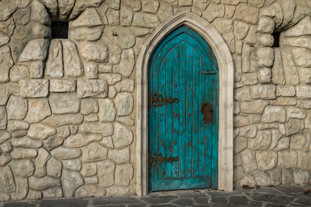 Old blue door with cobblestone wallの写真素材