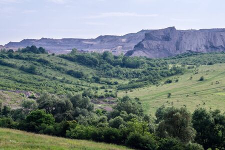 Slag heap near the industrial town of Hunedoara, Romania. A man-made mound  formed with the waste by-product from a foundry or furnace.の写真素材