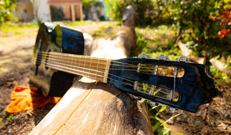 classical black guitar lying down view of the neck