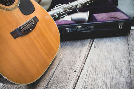 music on wood guitar and saxophone with blues country and jazz hat, vintage
