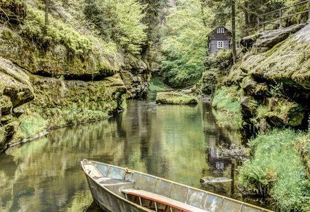 HDR shot of a boat on a river in Hrensko Meznaの写真素材