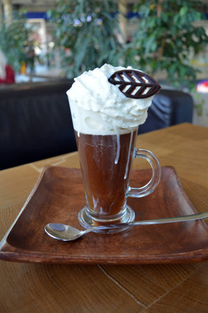 Delicious Viennese coffee in glass cup with whipped cream