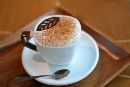 Delicious foamy cappuccino on the wooden tableの写真素材
