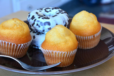 Homemade muffins  and muffins on a brown plate
