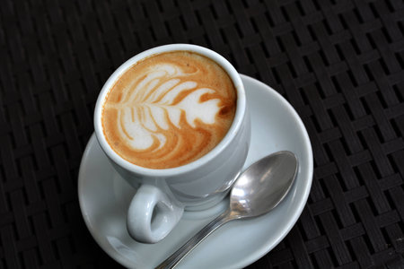 White Cup Of Foamy Cappuccino On A Black Backgroundの写真素材