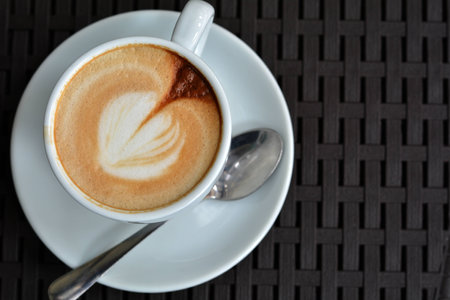 Cup of delicious foamy cappuccino on the black backgroundの写真素材
