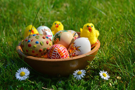 Easter Eggs with little chickens in green grass