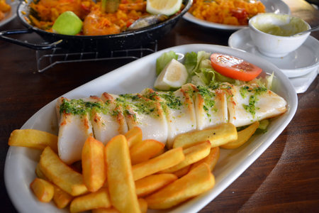 Grilled calamari, vegetables and french fries. Close up.の写真素材