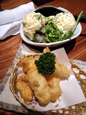 Japanese deep fried cheese sticks  on a basket on a restaurant table.の写真素材