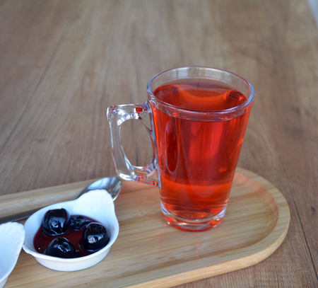 Mulled wine on a glass cup on a wooden table.の写真素材