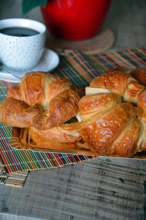 Breakfast with various of traditional French croissants, bread with chocolates, grapes on rustic.の写真素材