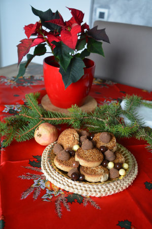 Christmas cookies on a plate on a decorated table. Dessert of cookies plate perfect for celebrating Christmasの写真素材