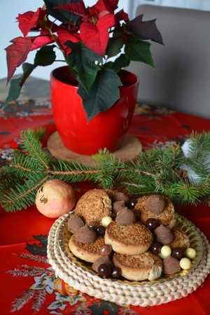 Christmas cookies on a plate on a decorated table. Dessert of cookies plate perfect for celebrating Christmasの写真素材