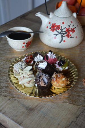 Christmas cookies on a plate and cup of coffee on a decorated table. Dessert of cookies plate perfect for celebrating Christmas.の写真素材