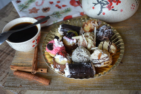 Christmas cookies on a plate and cup of coffee on a decorated table. Dessert of cookies plate perfect for celebrating Christmas.の写真素材