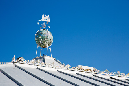 A white metal cladded roof with a wind indicator on the roofのeditorial素材