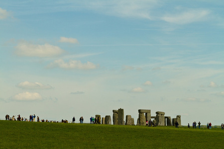 Amesbury, England - circa May 2014: A view towards the Stonehenge with people walking around taken from the side of the road on a sunny day with limited cloudsのeditorial素材