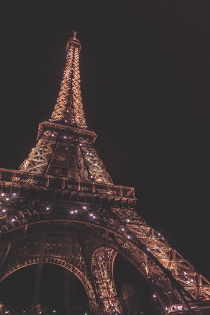 Paris France  circa September 2012: A night photograph of the Tour Eiffel taking underneath the structure looking up photos has an applied Vintage filterのeditorial素材