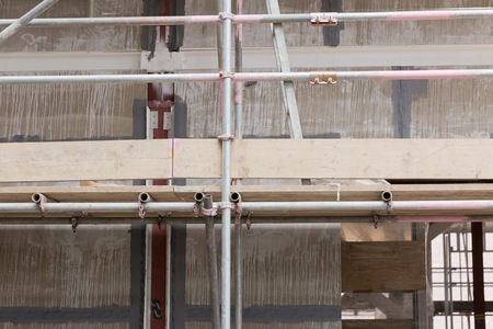 A construction site with concrete slabs built held together with scaffoldingの写真素材