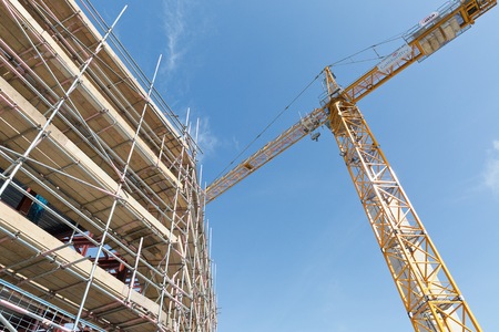 A construction site with concrete slabs built held together with scaffoldingの写真素材