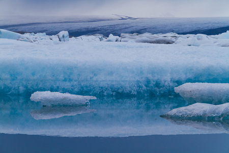 Luminous blue icebergs floating in Jokulsarlon glacial lagoon, Iceland