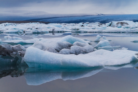 Luminous blue icebergs floating in Jokulsarlon glacial lagoon, Iceland