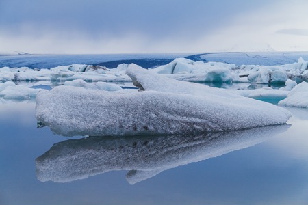 Luminous blue icebergs floating in Jokulsarlon glacial lagoon, Icelandの写真素材