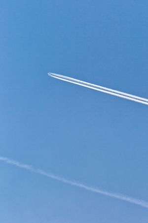 Airplane in the sky. An airplane trail across the sky