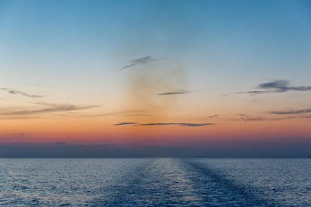 beautiful seascape with deep ocean waters and sunrise cloudscapeの写真素材