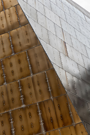 Detail of brown stainless steel facade showing rivits on each panelの写真素材