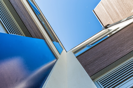 Disappearing glass office buildings in the morning, wide angle viewの写真素材