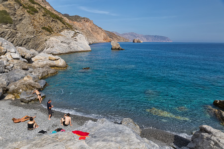 Amorgos Island, Greece - October 2015: Company of young people on the beach of a Greek Island, Amorgosのeditorial素材