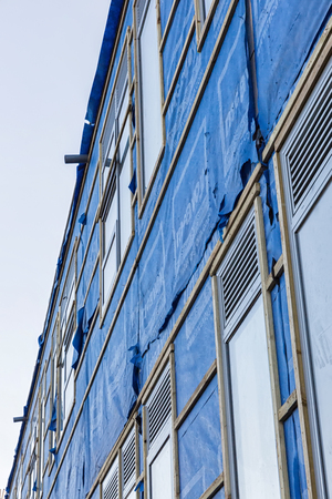 Poole, England - December 2014: Construction Site wrapped by blue waterproof membrane sheetsのeditorial素材