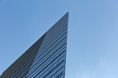 Berlin, Germany - July 2015: Architectural abstract of a curtain wall skyscraper, blue backgroundのeditorial素材