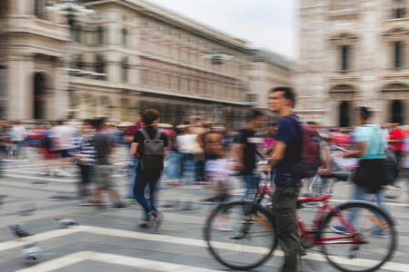 Panning photograph of people walking on a shopping street with camera made motion blurの写真素材