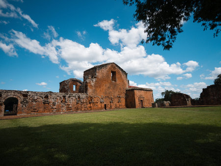 Panoramic view of ancient ruins in an open space with grass in the foreground and blue sky with voluminous clouds. Ideal for tourism, history, heritage, culture, architecture and travel campaigns.の写真素材
