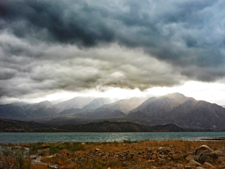 Dramatic clouds above lake near Mendoza in Argentinian Andesの写真素材